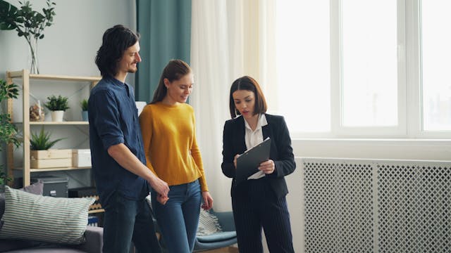 A%20landlord%20showing%20tenants%20information%20on%20a%20clipboard A%20landlord%20showing%20tenants%20information%20on%20a%20clipboard